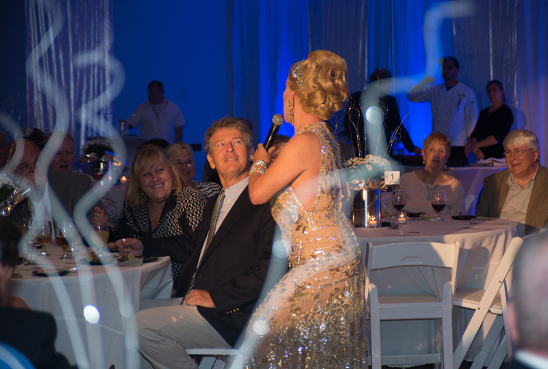 Steve McGuiness gets the royal treatment from performer Christopher Peterson during the Pure Silver Gala. BY DENY HOWETH